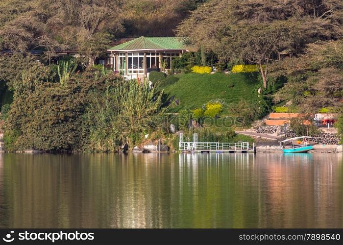 The beautiful Babogaya Lake warmly lit by the rising sun on a clear morning in Debre Zeit, Ethiopia.