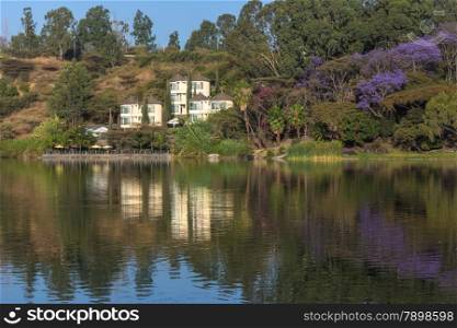 The beautiful Babogaya Lake warmly lit by the rising sun on a clear morning in Debre Zeit, Ethiopia.