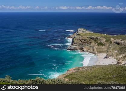 The beautiful coastal lines with blue and turquoise colored water of the Atlantic ocean near Cape Point in South Africa