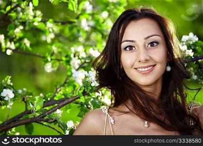 The beautiful girl in a dress against trees