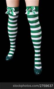 The beautiful legs of a woman in green and white stripes, with greenheels for black background.