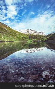 the beautiful Norwegian landscape. mountains in snow and reflection in water