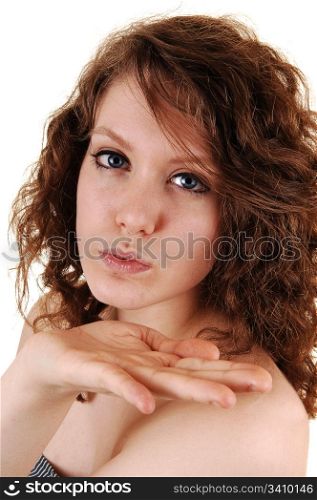 The beautiful smiling face of a young woman in closeup, blowing akiss, with her nice blue eyes, on white background.