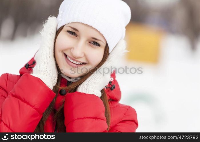 The beautiful smiling woman on walk in winter wood. Winter walk