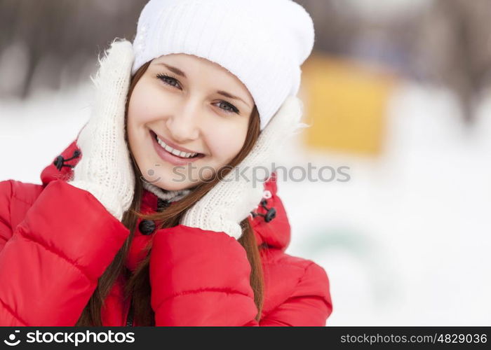 The beautiful smiling woman on walk in winter wood. Winter walk