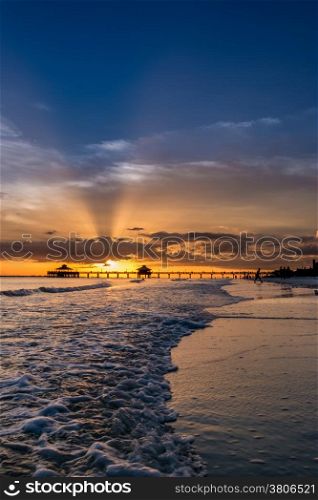 The beautiful sun setting on the shores of Fort Myers Beach located on Estero Island in Florida, United States of America