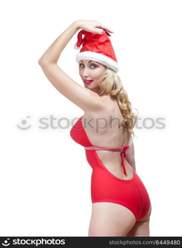 The beautiful woman in a red bathing suit and a red cap of Santa Claus