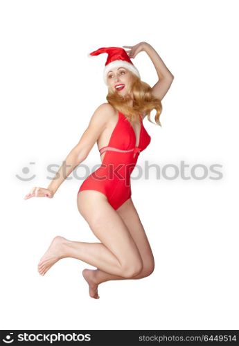 The beautiful woman in a red bathing suit and a red cap of Santa Claus