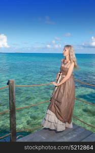 The beautiful woman on a wooden scaffold over the sea