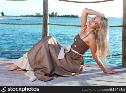 The beautiful woman on a wooden scaffold over the sea