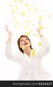 The beautiful woman throws above a head yellow scraps of a paper on a white background. Good-bye paper work!