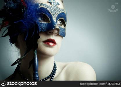 The beautiful young girl in a mysterious mask