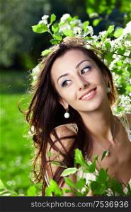 The beautiful young girl in blossoming trees