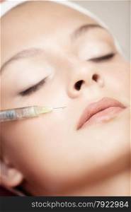 The Beautiful Young Woman Having Rejuvenating Injection against the Wrinkles
