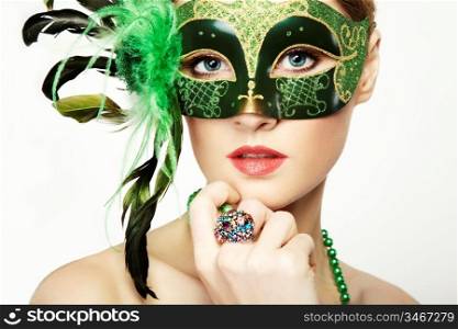 The beautiful young woman in a green mysterious venetian mask