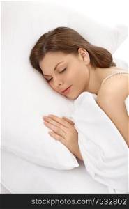 The beautiful young woman it is sweet sleeps in white bed