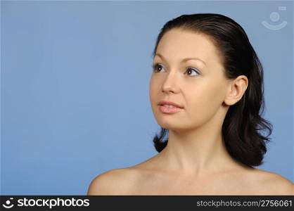 The beautiful young woman. Natural beauty. It is isolated on a blue background