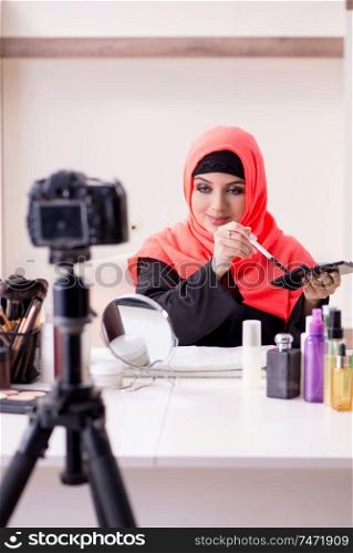 The beauty blogger in hijab recording video for her blog . Beauty blogger in hijab recording video for her blog 