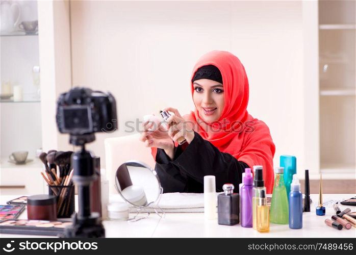 The beauty blogger in hijab recording video for her blog . Beauty blogger in hijab recording video for her blog