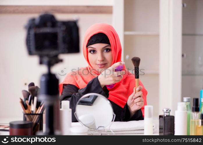 The beauty blogger in hijab recording video for her blog. Beauty blogger in hijab recording video for her blog