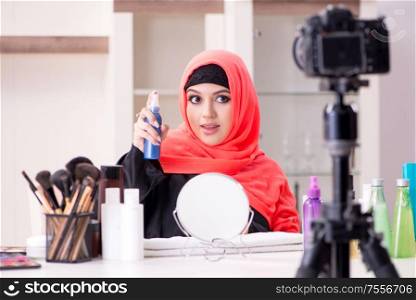 The beauty blogger in hijab recording video for her blog. Beauty blogger in hijab recording video for her blog
