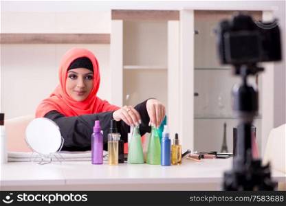 The beauty blogger in hijab recording video for her blog. Beauty blogger in hijab recording video for her blog
