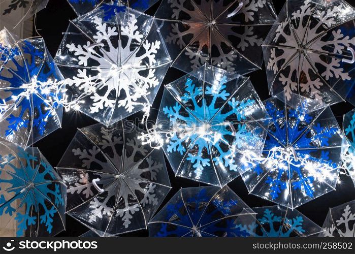 The beauty of white umbrellas illuminated by Christmas lights decorating the streets of Agueda Portugal
