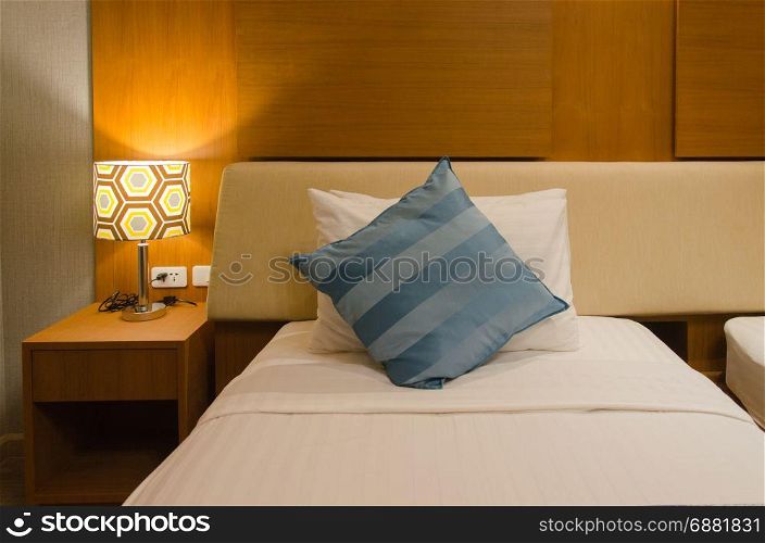 The bed and pillows, lamps and interior room.