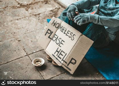 The beggars sat beside the street with a homeless message. Please help and work with food.