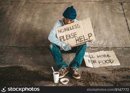 The beggars sit under the bridge with a homeless message. Please help.
