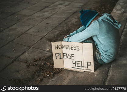 The beggars sit under the bridge with a homeless message. Please help.