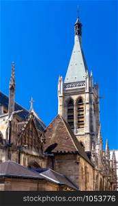 The bell tower of San Chapelle on a background of blue sky in the early morning. Paris. France.. Paris. Chapel of Saint Chapelle.