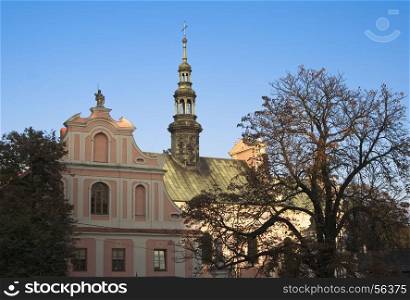 The bell tower of the church of St. Michael on the background of blue sky in the Polish town of Sandomierz