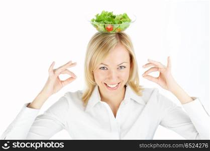 The benevolent girl with a salad dish on a head, isolated. Let?s smile!
