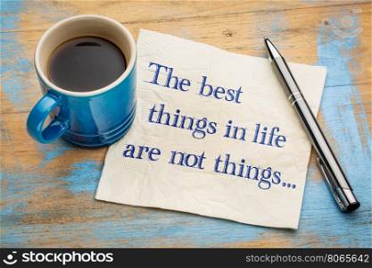The best things in life are not things - handwriting on a napkin with a cup of espresso coffee