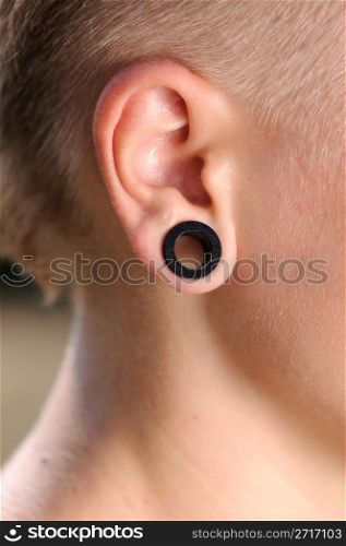 The big aperture in an ear at the teenager