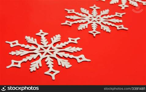 The big snowflake on a red background. Closeup