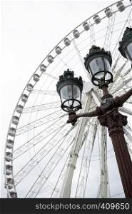 The Big Wheel at Place de la Concorde and a street lamp in the foreground in Paris. France