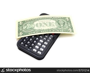 The black calculator on a white background and on it lies one dollar a denomination