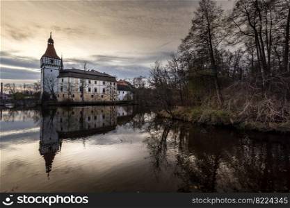 The Blatna water castle in the autumn sunset in the South Bohemian region is one of the best-preserved water manors in the Czech Republic.