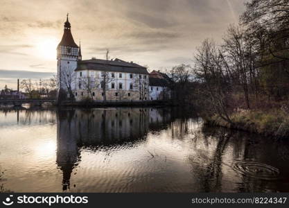 The Blatna water castle in the autumn sunset in the South Bohemian region is one of the best-preserved water manors in the Czech Republic.