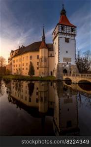 The Blatna water castle in the autumn sunset in the South Bohemian region is one of the best-preserved water manors in the Czech Republic.