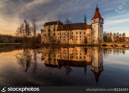 The Blatna water castle in the autumn sunset in the South Bohemian region is one of the best-preserved water manors in the Czech Republic.