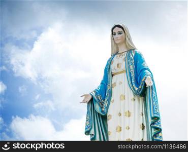 The Blessed Virgin Mary Statue blue sky background.