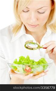 The blonde examining in a magnifier a plate with salad