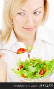 The blonde holds a plug with the salad, isolated. To eat or not to eat?