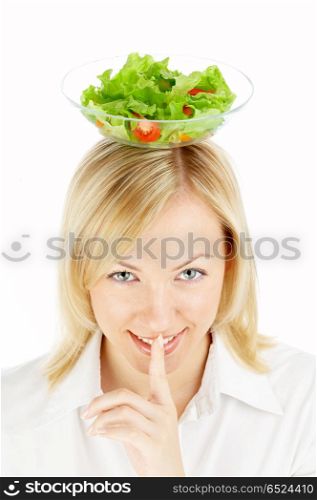 The blonde holds salad on a head. Beauty secret