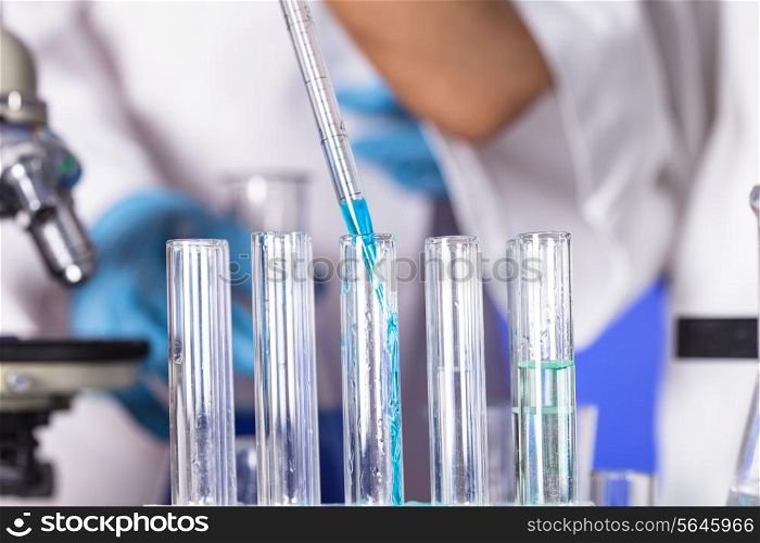 The blue drop from pipette in laboratory tubes