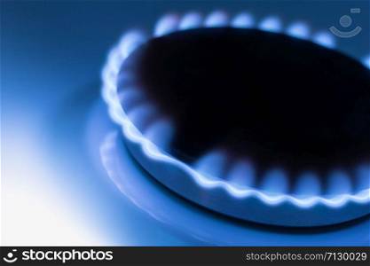 The blue flame from the burner of a gas stove