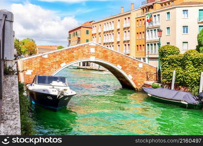 The Boats moored by the bridge in Dorsoduro, a typical old street of Venice, Italy.